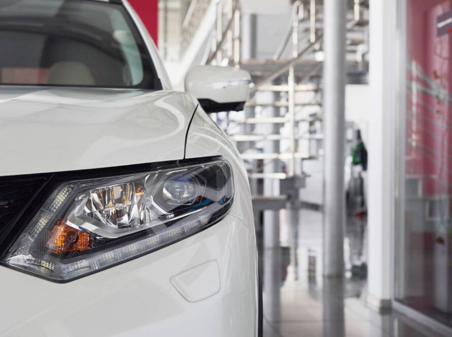 Close-up of luxury car hood and headlights after auto body repair and detailing